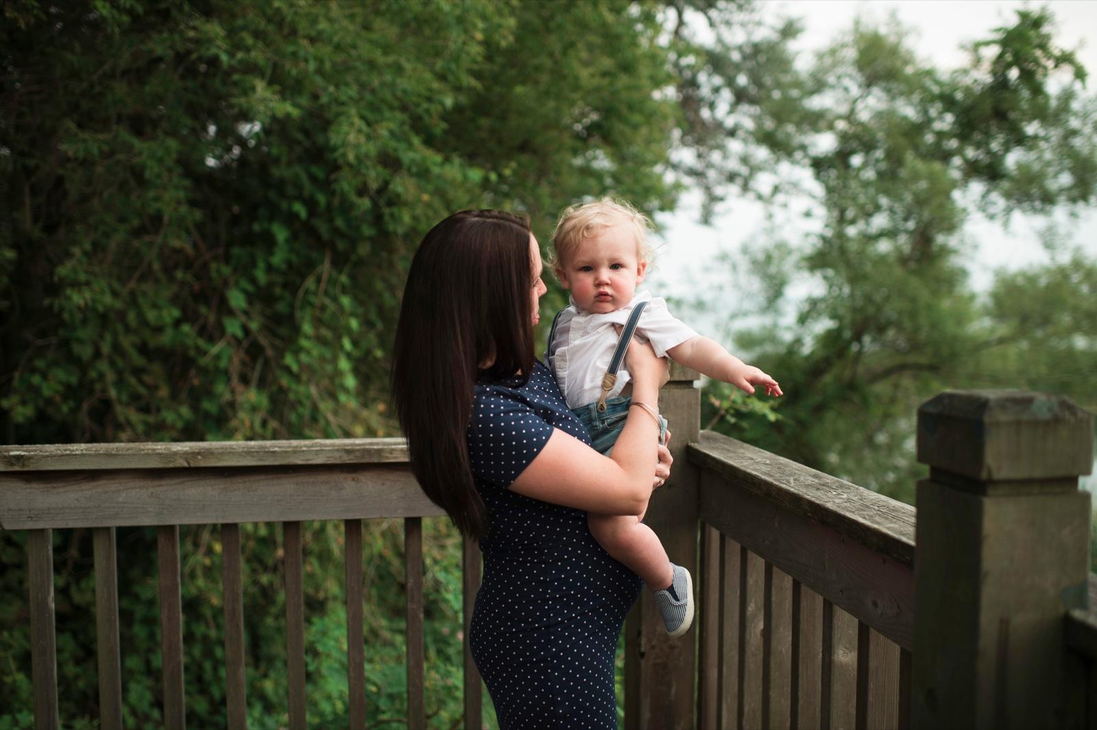 Mother holding baby on porch